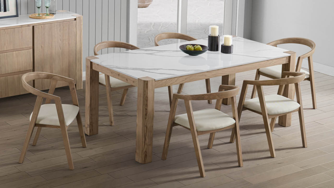 The Tivoli dining chair features organic curves, fabric seating, and a curved backrest for comfort. Perfectly complementing the table, showcasing a grey-veined stone top. Available in sizes for 6 or 8 people, with made-to-order options.