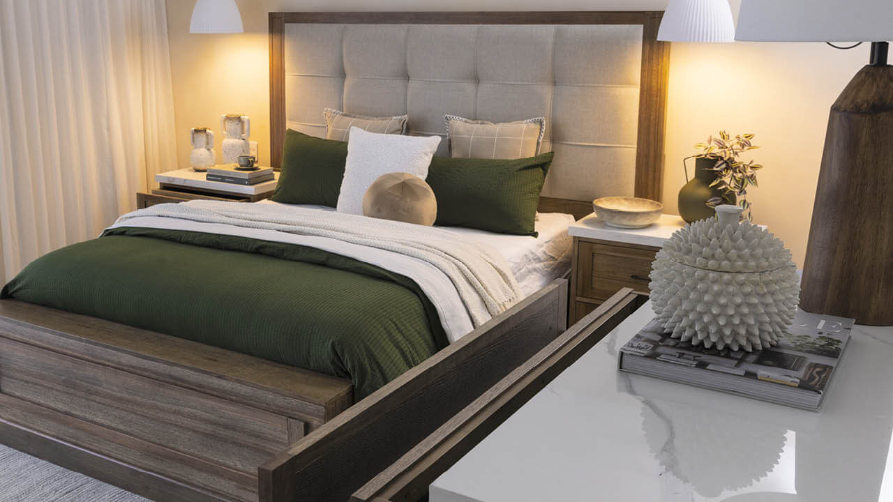 Matteo bedroom set with timber bed frame, upholstered headboard, bedside tables, and layered bedding in neutral tones.
