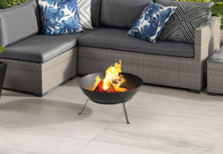 fire pit on patio with grey furniture