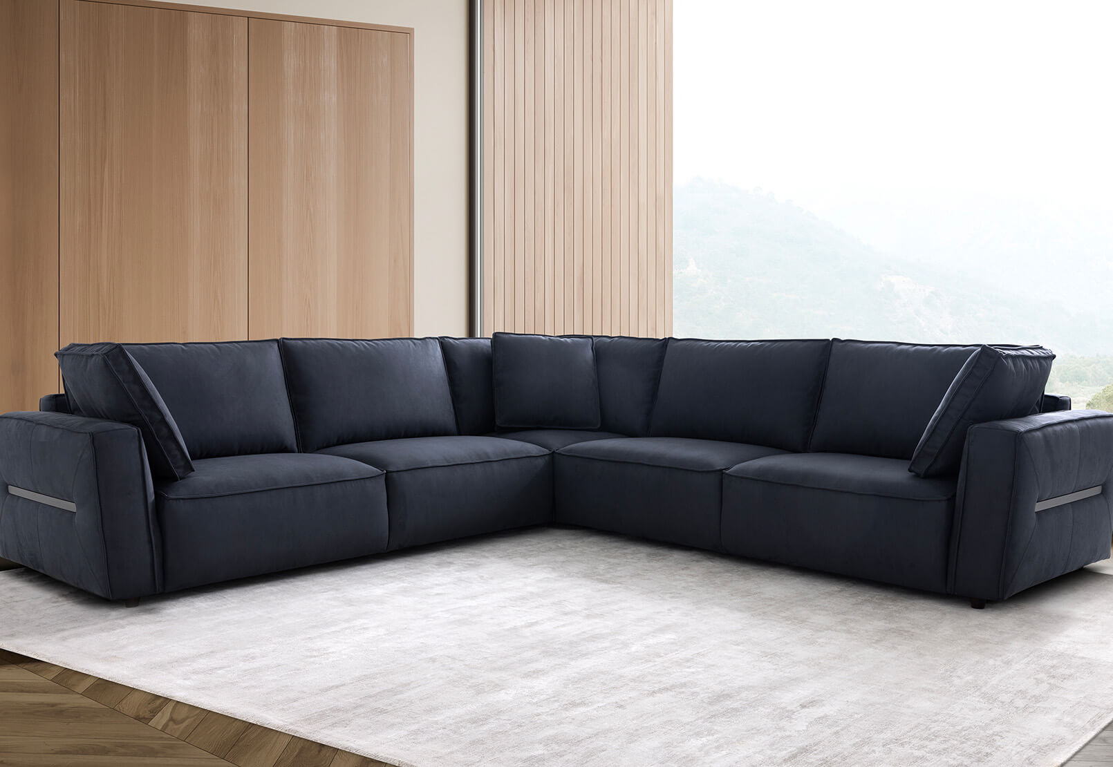 Modern living room featuring the Cimiano corner lounge in midnight blue, arranged with a soft grey rug under natural light.